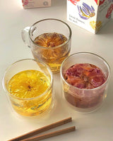 Shark Tank Special! Assorted flower teas in glass cups showcasing blooming tea experience with chopsticks.