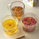 Shark Tank Special! Assorted flower teas in glass cups showcasing blooming tea experience with chopsticks.