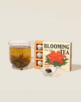 Inner Radiance Blooming Tea displayed with brewed tea and handmade tea truffles in elegant packaging.