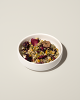 Sleep Tea herbal blend with calming flowers and herbs in a white bowl for relaxation and restful sleep.