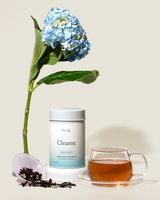 Complete functional tea set featuring Cleanse herbal tea, a tea cup, and a blue hydrangea flower.