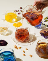 Daily Ritual Set featuring vibrant flower teas being poured into glasses for a sensory experience.