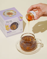 Iconic Bloom Trio set featuring Blue Lotus tea being poured into a glass cup for a relaxing experience.