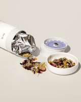 A container of Sleep Tea with a blend of calming herbs spilling out for relaxation and restful sleep.