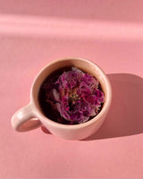 Shangri-la Rose! in a pink cup featuring dried rose petals, symbolizing floral aroma and relaxation.