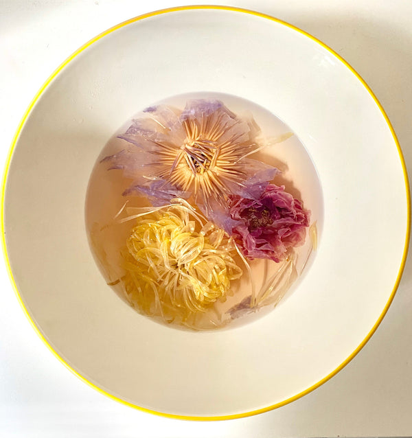 Rose Tea Hair Rinse with dried colorful flowers in water, showcasing the beauty of rose and herbal infusion.