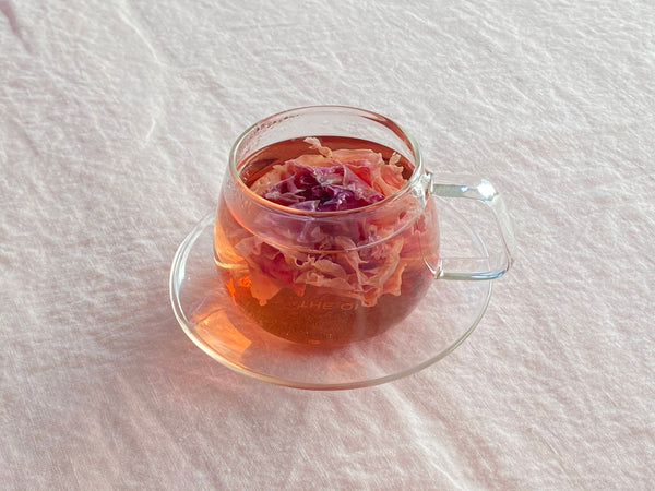 Organic Flower Tea in Glass Cup with Saucer