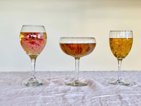 Three Wine Glasses with Various flower teas